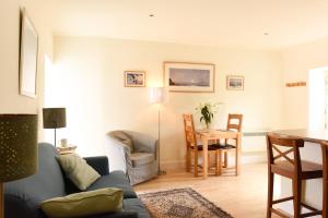 a living room with a couch and a table at The Wee Bothy at East Lothian Cottages in Lennoxlove