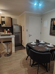 a kitchen and dining room with a table in a room at Departamento Los Poetas in Temuco