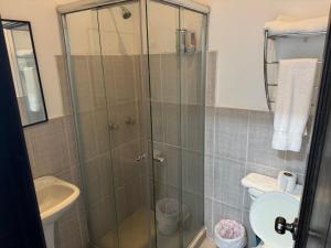 a bathroom with a shower with a toilet and a sink at Mansión del Parque by CS in Guaranda