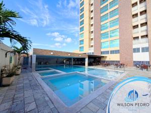 a swimming pool in front of a building at Piazza diRoma - Acqua Park e Splash in Caldas Novas
