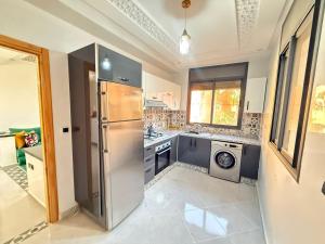 a kitchen with a stainless steel refrigerator and a dishwasher at Spacious and Comfortable Apartment in Beni Mellal