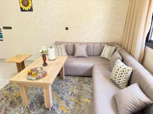 a living room with a couch and a table at Spacious and Comfortable Apartment in Beni Mellal