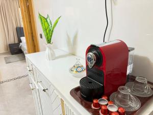 a red toaster sitting on top of a counter at Spacious and Comfortable Apartment in Beni Mellal +4 photos