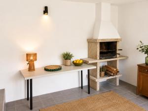 a kitchen with a table and a pizza oven at Casa D'os Eiras in Aguiar da Beira