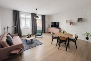 a living room with a couch and a table at Apartmán Hubertus No. 17 in Karlova Studánka