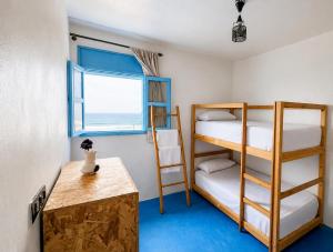a room with two bunk beds and a window at Coast anza house in Agadir