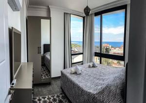 a bedroom with a bed and a view of the ocean at Beyaz Kosk in Demre +35 photos