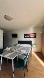 a bedroom with a bed and a table with a chair at Apartments Coko in Omiš