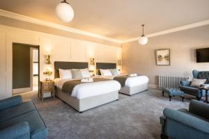 a hotel room with two beds and a couch at Creighton Hotel in Cluain Eois +13 photos