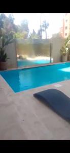 a swimming pool with blue water in a house at Appartement luxe hivernage in Marrakesh