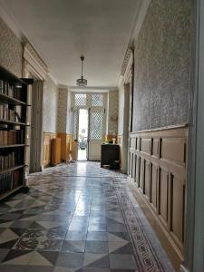 an empty hallway with a library with a book shelf at Fleurs et Abeilles in Faye-lʼAbbesse +7 photos