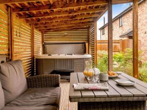 a patio with a table and an outdoor grill at 2 Bed in Weymouth oc-75200 in Weymouth