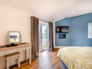 a bedroom with a bed and a desk with a mirror at 2 Bed in Weymouth oc-75200 in Weymouth
