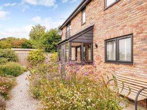 a brick house with a bench in front of it at 2 Bed in Weymouth oc-75200 in Weymouth