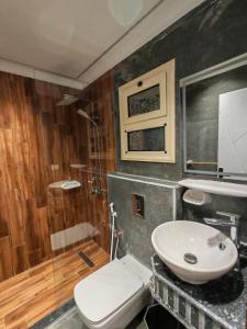 a bathroom with a toilet and a sink and a shower at LuXURY STUDIOS MATROUH 3 in Marsa Matruh