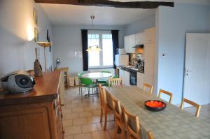 a kitchen and dining room with a table and chairs at Cote Jardin in Grandhan
