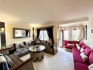 a living room with couches and a table at Elegant Beach View Apartment in Kabila Vista in Marina Smir