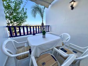 a white table and chairs on a balcony at Elegant Beach View Apartment in Kabila Vista in Marina Smir