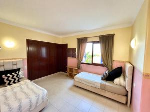 a bedroom with two beds and a window at Elegant Beach View Apartment in Kabila Vista in Marina Smir +24 photos