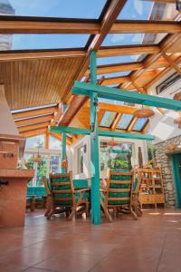 a conservatory with chairs and a wooden ceiling at vila Barbara - Vysoké Tatry in Stará Lesná