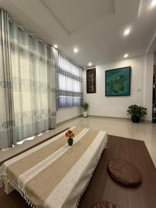a large living room with a large window with curtains at Hoom Villa Thành Nội - Villa 3 phòng ngủ in Thôn An Hòa +9 photos