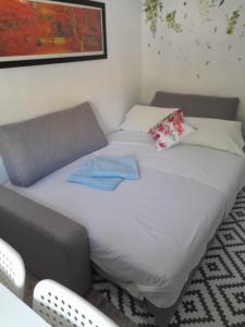 a bed in a room with two towels on it at A Beautiful Townhouse with a roof top terrace in Rute +55 photos