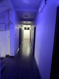 an empty hallway with purple lights in a building at Hotal Relax in Saharsa