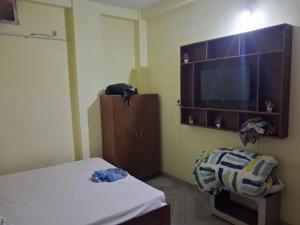 a room with a bed and a flat screen tv at Hotal Relax in Saharsa