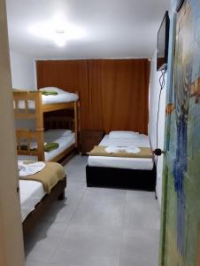 a room with two bunk beds and a painting on the wall at Alojamiento donde Nur in Filandia