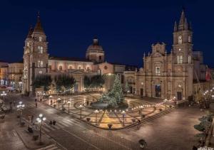 a large building with a christmas tree in front of it at Sicilia Bedda C&G in Acireale