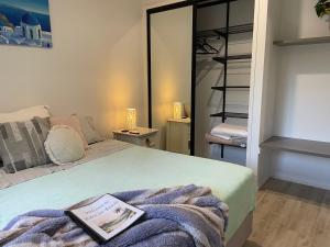 a bedroom with a bed with a book on it at Eden on Beach in Palm Cove