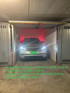 a car in a garage with its lights on at Tiffany - Netflix Disney per 8pp con Garage Box in Trieste