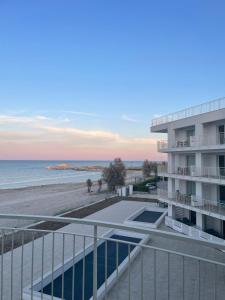 a view of the beach from the balcony of a building at Sumus Smart Residence in Porto SantʼElpidio