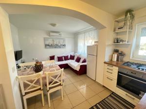 a kitchen and living room with a table and a couch at Apartment Vito in Mandre