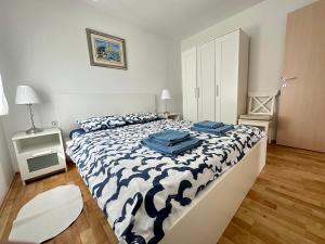 a bedroom with a bed with blue towels on it at Apartment Vito in Mandre