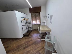 a room with a desk and a table and a ladder at Holiday House Herculaneum in Ercolano +12 photos