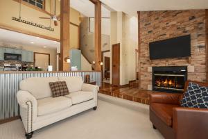 a living room with a couch and a fireplace at Mountainside Unit B-8 in Granby