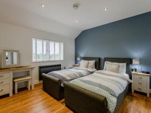 a bedroom with two beds and a desk and a television at 2 Bed in Weymouth oc-75201 in Weymouth