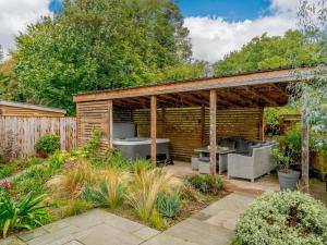 a wooden pergola in a garden at 2 Bed in Weymouth oc-75201 in Weymouth