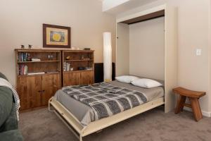 a bedroom with a bed and a book shelf at Waterside West A206 in Fraser