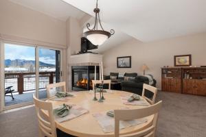 a dining room with a table and a fireplace at Waterside West A206 in Fraser
