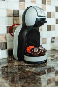 a coffee maker is sitting on a counter with cupcakes at Mathios Apartments Falassarna in Falasarna