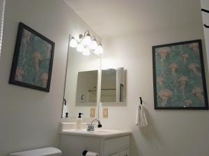 a bathroom with a sink and a mirror at Beach Hoppers' Hideaway in Cape Charles +21 photos