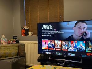 a television screen with a man talking on a cell phone at 40 kennett gardens in Gloucester