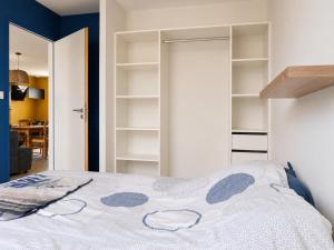 a bedroom with a bed and open shelves at Maison Jean Moulin in Saint-Augustin