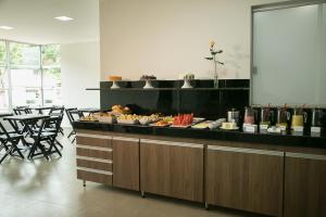 a buffet in a restaurant with a lot of food at Peçanha Grande Hotel in Peçanha
