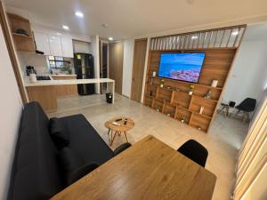 a living room with a couch and a table at Praseo in Serena del Mar