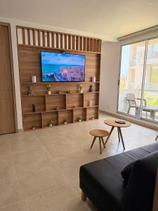 a living room with a flat screen tv on a wall at Praseo in Serena del Mar