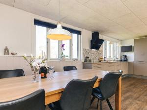 a dining room with a wooden table and chairs at 6 person holiday home in Vinderup-By Traum in Vinderup