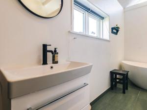 a white bathroom with a sink and a mirror at 6 person holiday home in Vinderup-By Traum in Vinderup +32 photos